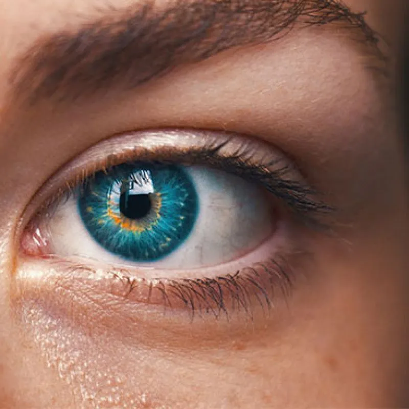 A close-up of a bright blue-green eye